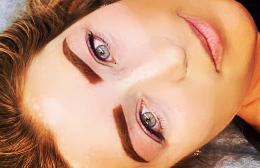 Angled view of defined brown eyebrow arches