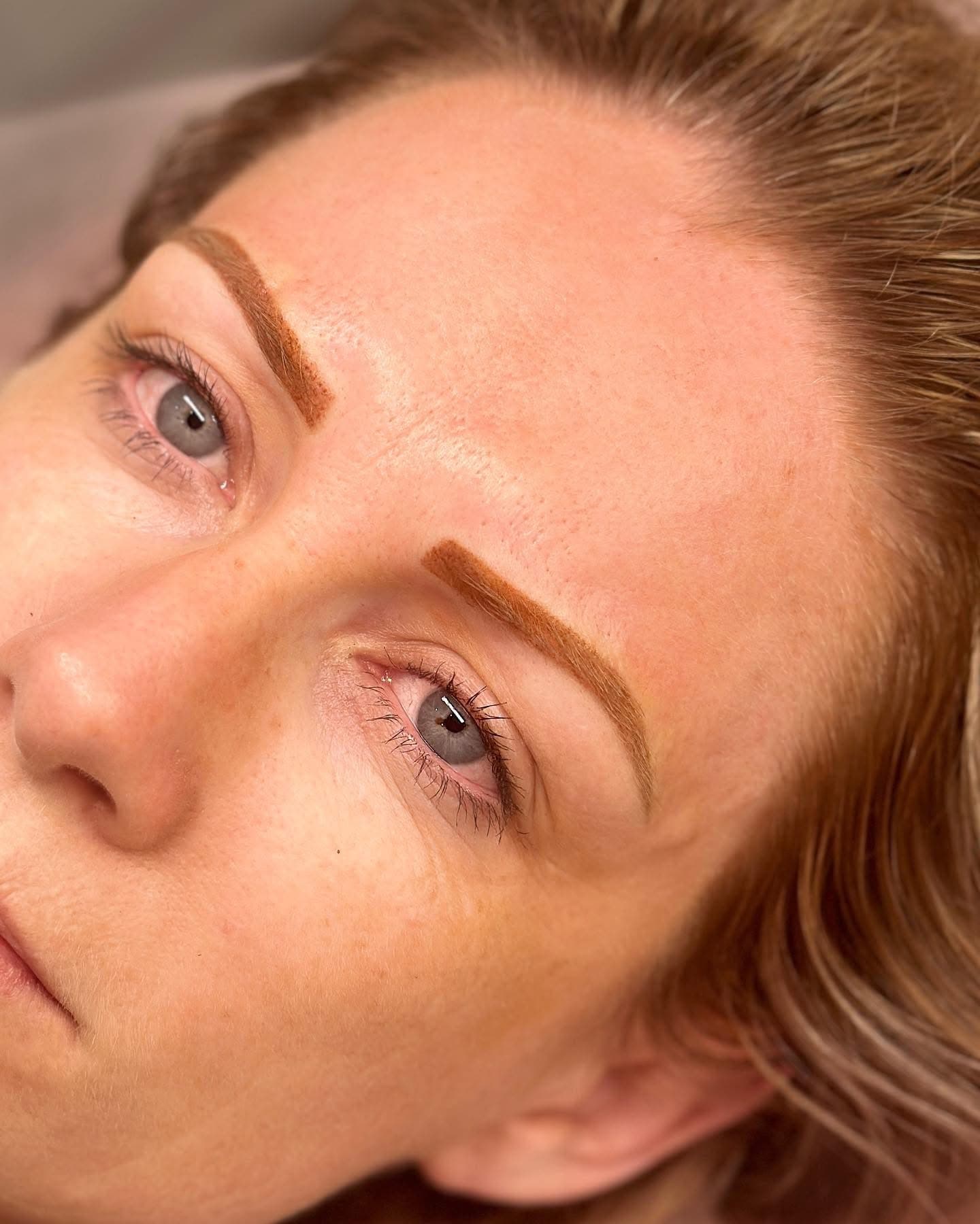 Close-up of softly shaded brown eyebrows with defined arches
