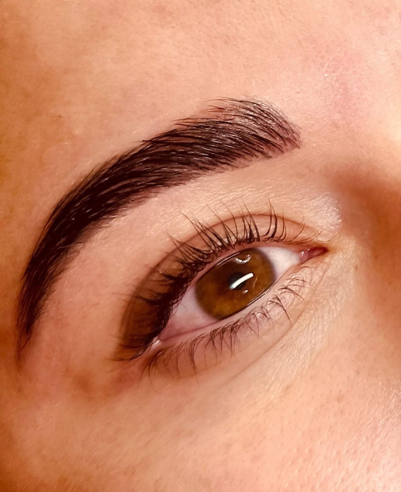 Close-up of a brown eye with subtle eyeliner along the upper lash line